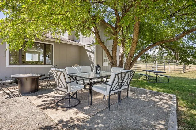 a view of a patio with table and chairs and potted plants