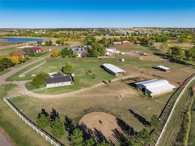 an aerial view of a house with a yard and lake view