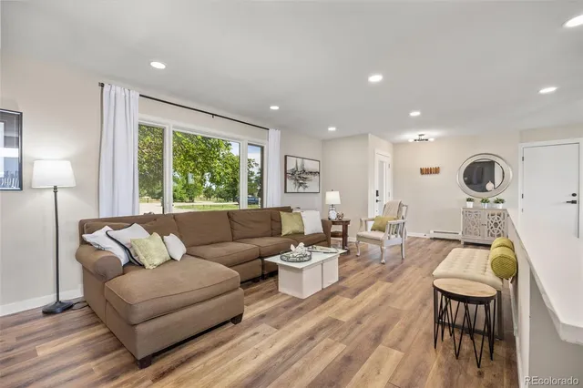 a living room with furniture and a large window