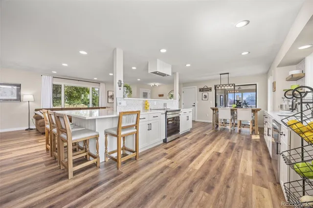 a dining room with furniture and wooden floor