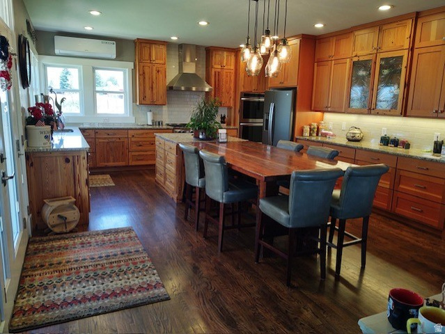 2170 Highway 357 Beaver, UT 84713 - Photo 22 of 56 Wood-finish flooring, recessed lighting, wood cabinetry, built-in double oven, and a stainless steel range hood