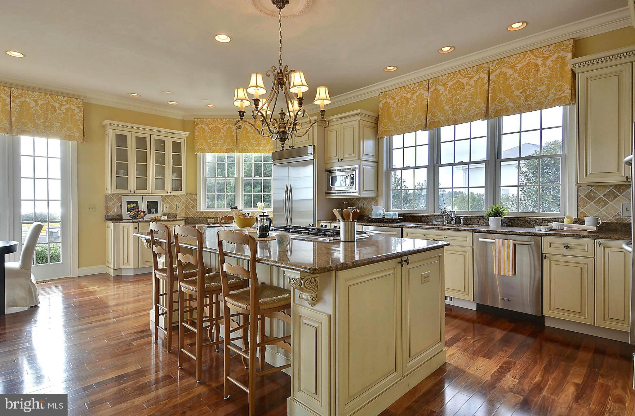 2925 Cox Neck Road East Chester, MD 21619 - Photo 4 of 30 a kitchen with center island and windows