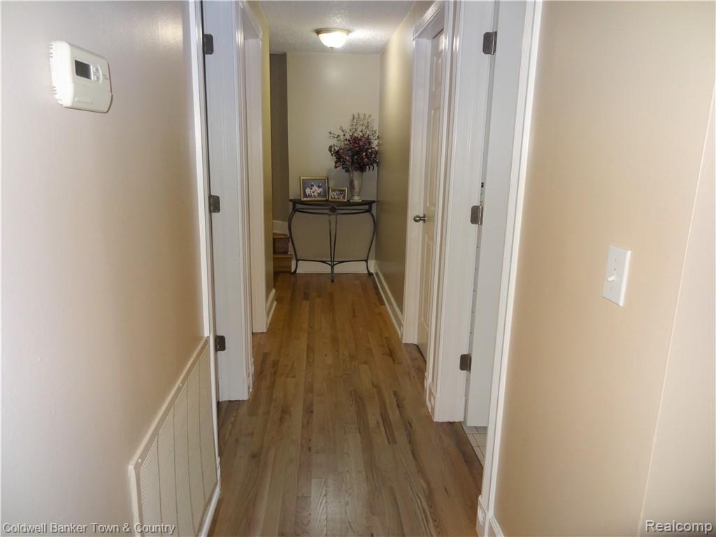 223 Ruppert Street Commerce Township, MI 48382 - Photo 15 of 31 Hallway to bathroom, bedrooms, and utility/laundry room.