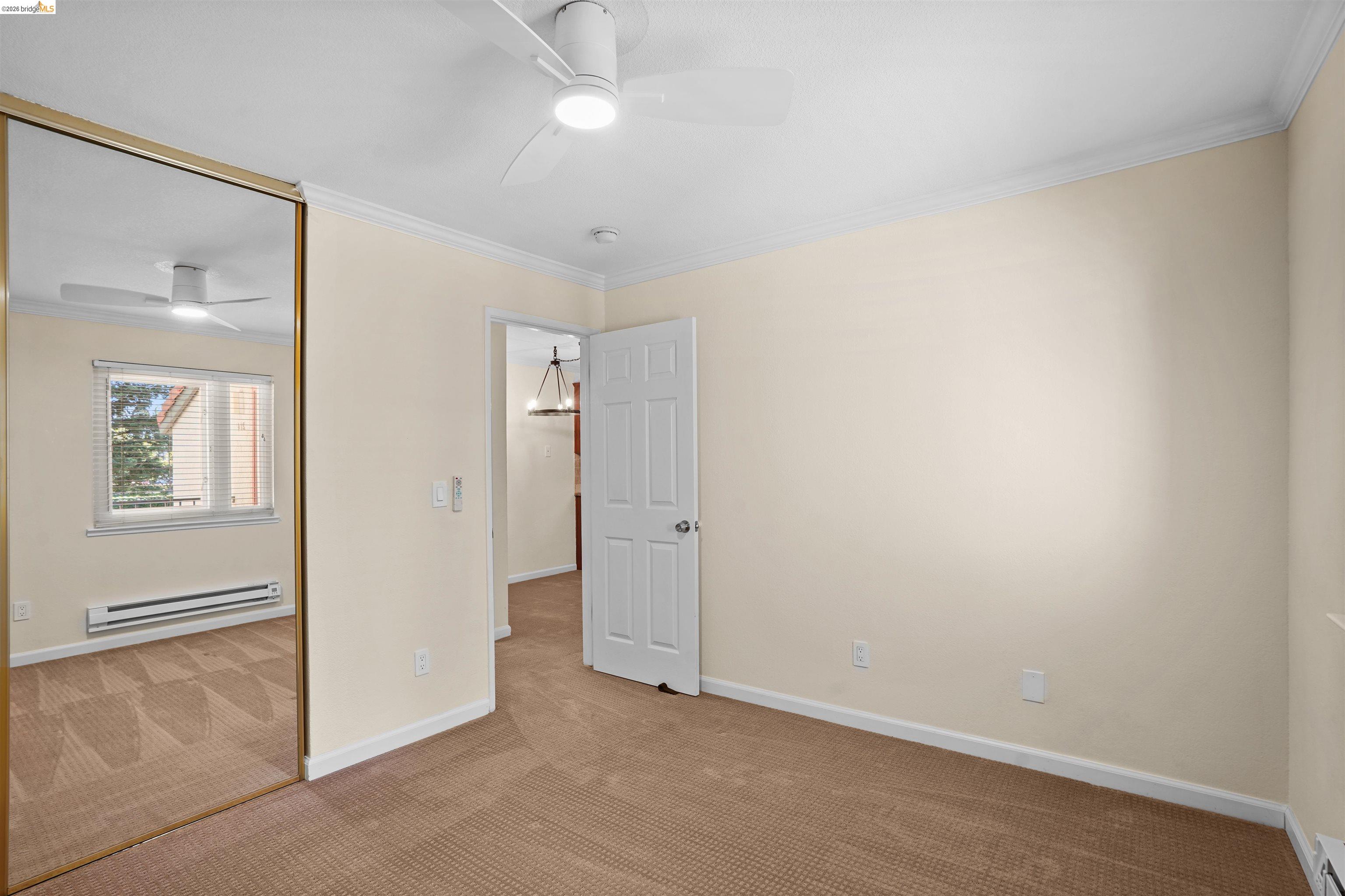 1505 Kirker Pass Road, Unit 214 Concord, CA 94521 - Photo 42 of 55 Bedroom featuring warm-toned carpet flooring, a ceiling fan with integrated lighting, and crown molding