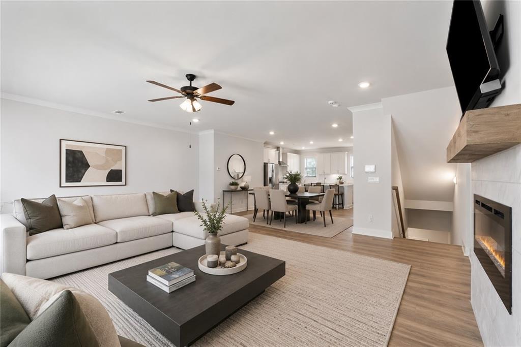 3334 Swallowtail Terrace Duluth, GA 30096 - Photo 2 of 37 a living room with furniture a fireplace and a flat screen tv