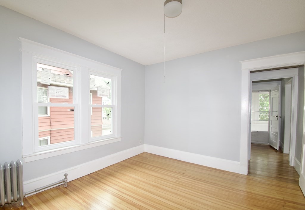 80-82 Silver Street Springfield, MA 01107 - Photo 11 of 31 a view of an empty room with wooden floor and a window