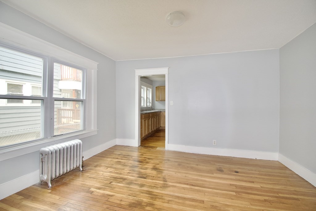 80-82 Silver Street Springfield, MA 01107 - Photo 15 of 31 a view of an empty room with wooden floor and a window