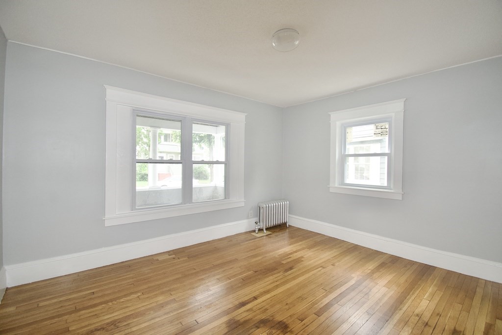 80-82 Silver Street Springfield, MA 01107 - Photo 17 of 31 an empty room with wooden floor and windows