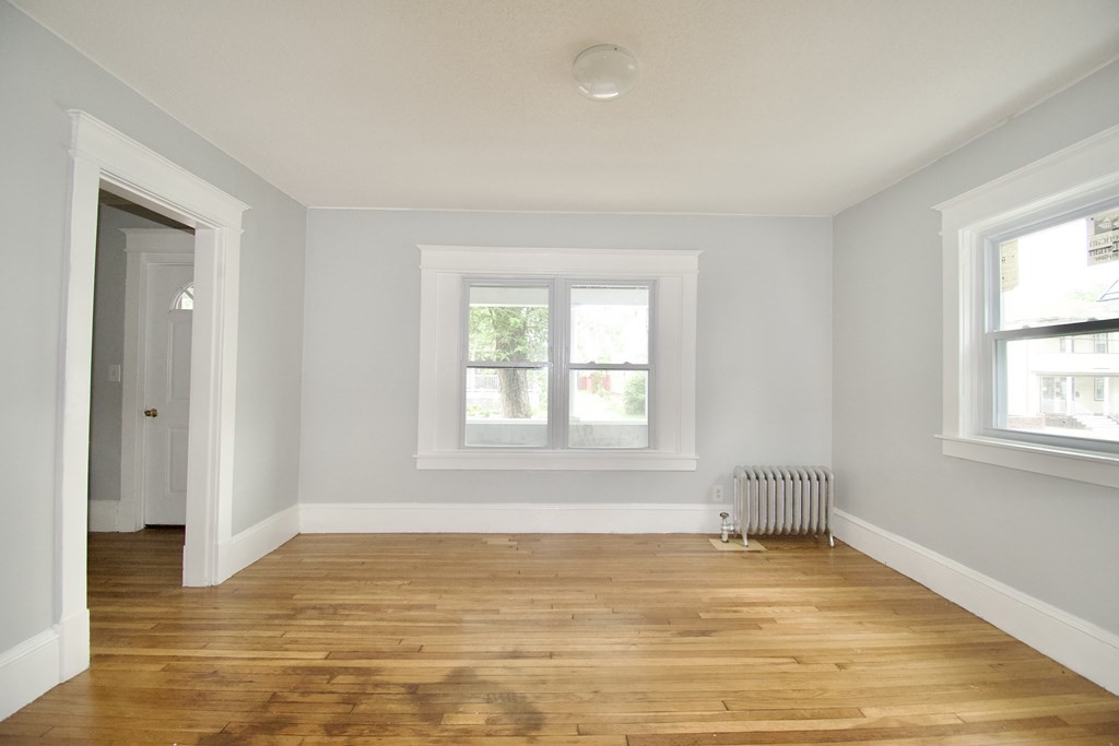 80-82 Silver Street Springfield, MA 01107 - Photo 18 of 31 a view of an empty room with wooden floor and a window