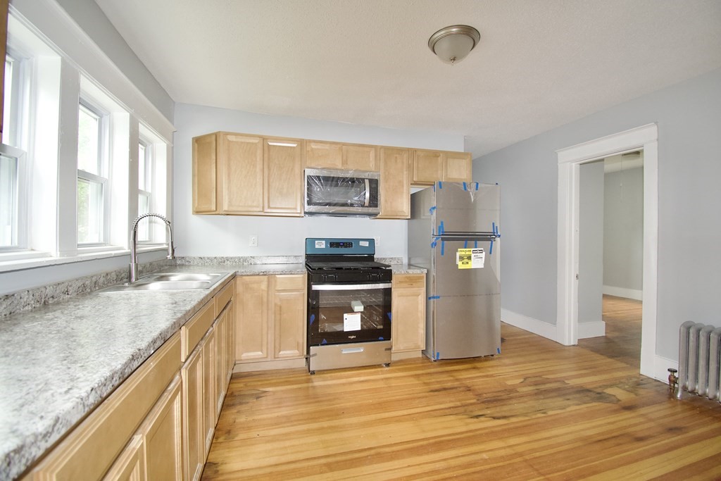 80-82 Silver Street Springfield, MA 01107 - Photo 24 of 31 a kitchen with granite countertop a refrigerator stove top oven and sink