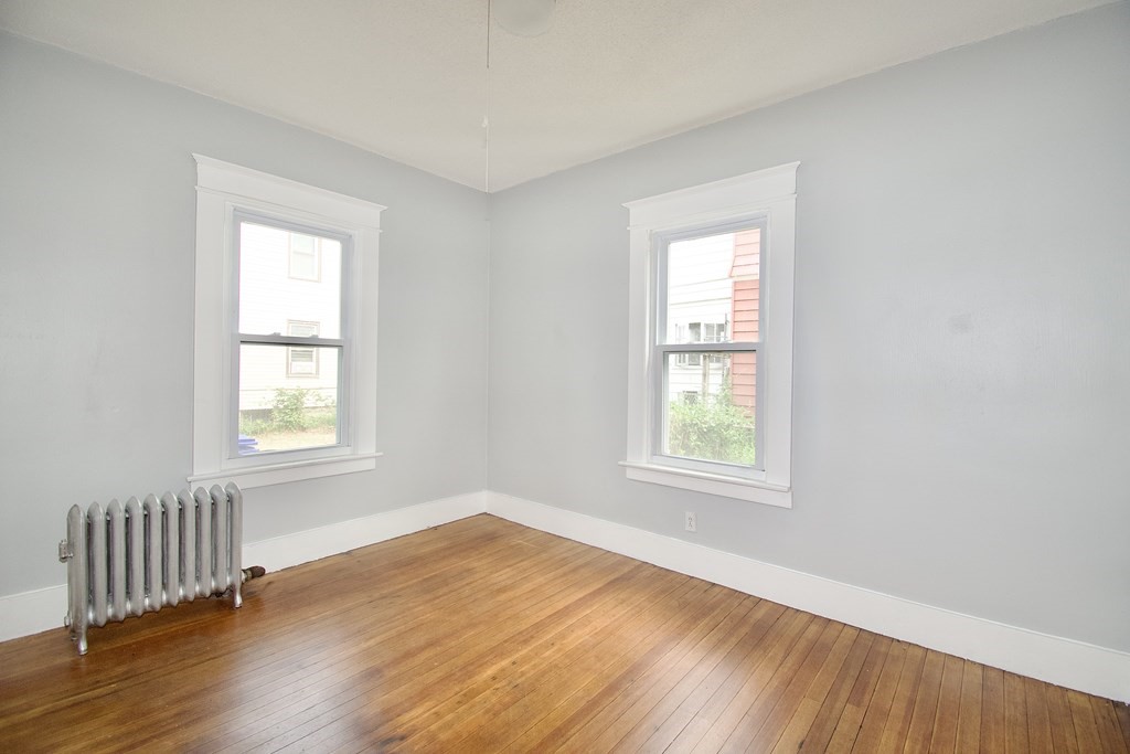 80-82 Silver Street Springfield, MA 01107 - Photo 27 of 31 a view of an empty room with wooden floor and a window