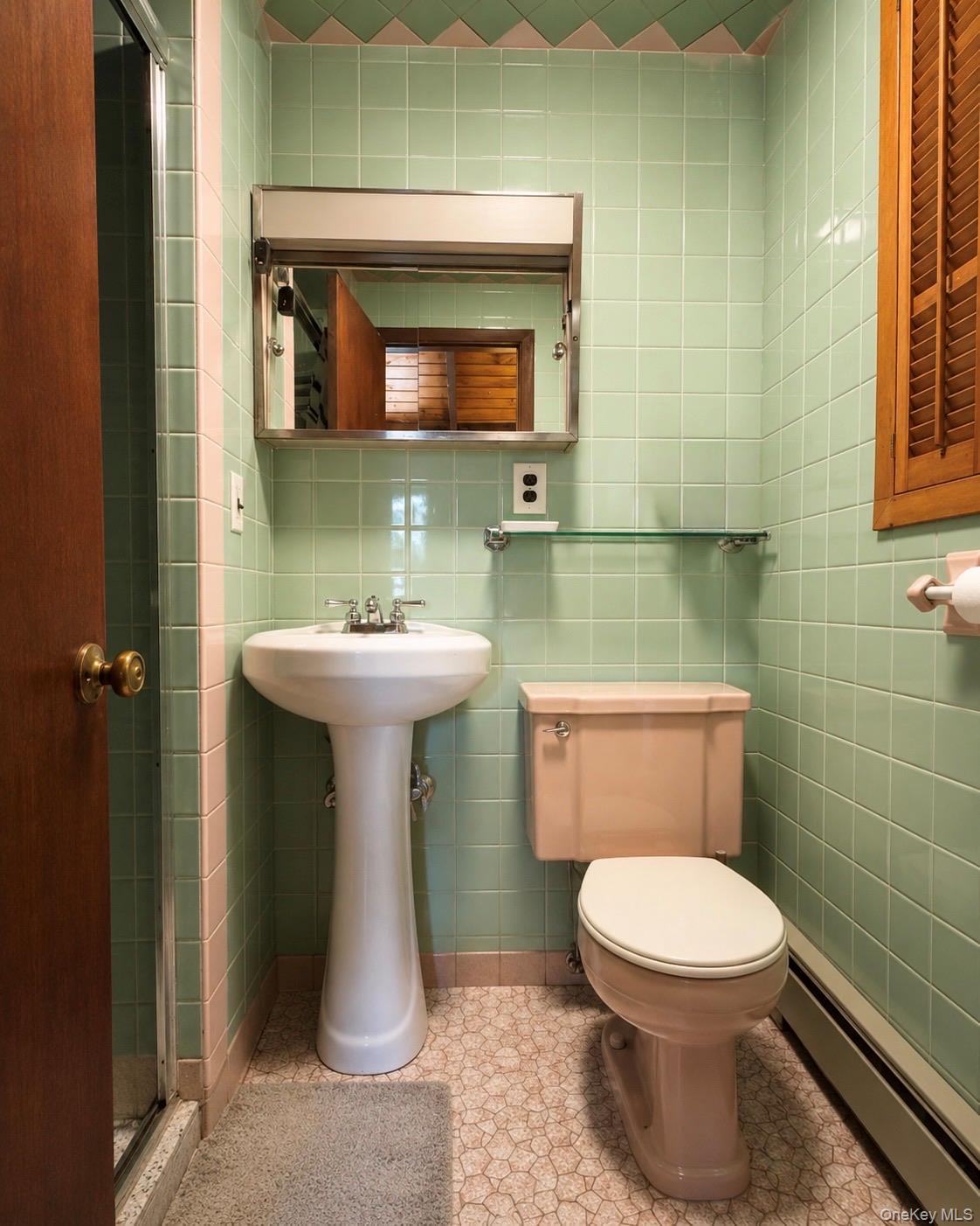 177 Davos Road Woodridge, NY 12789 - Photo 8 of 19 a bathroom with a toilet sink and mirror