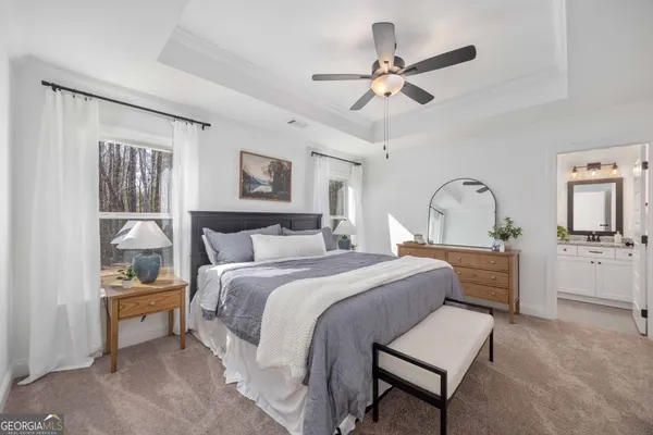 a bedroom with a bed and a chandelier