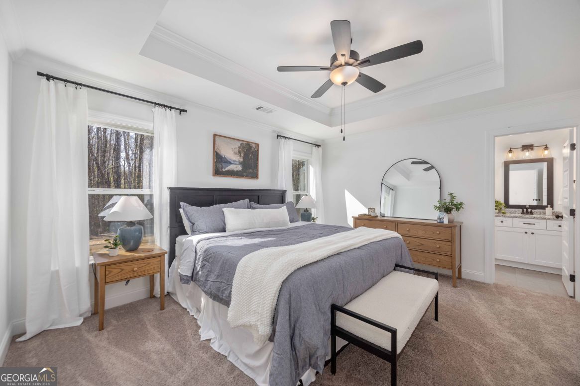 21 Rivers Edge Lane Franklin, GA 30217 - Photo 15 of 26 a bedroom with a bed and a chandelier