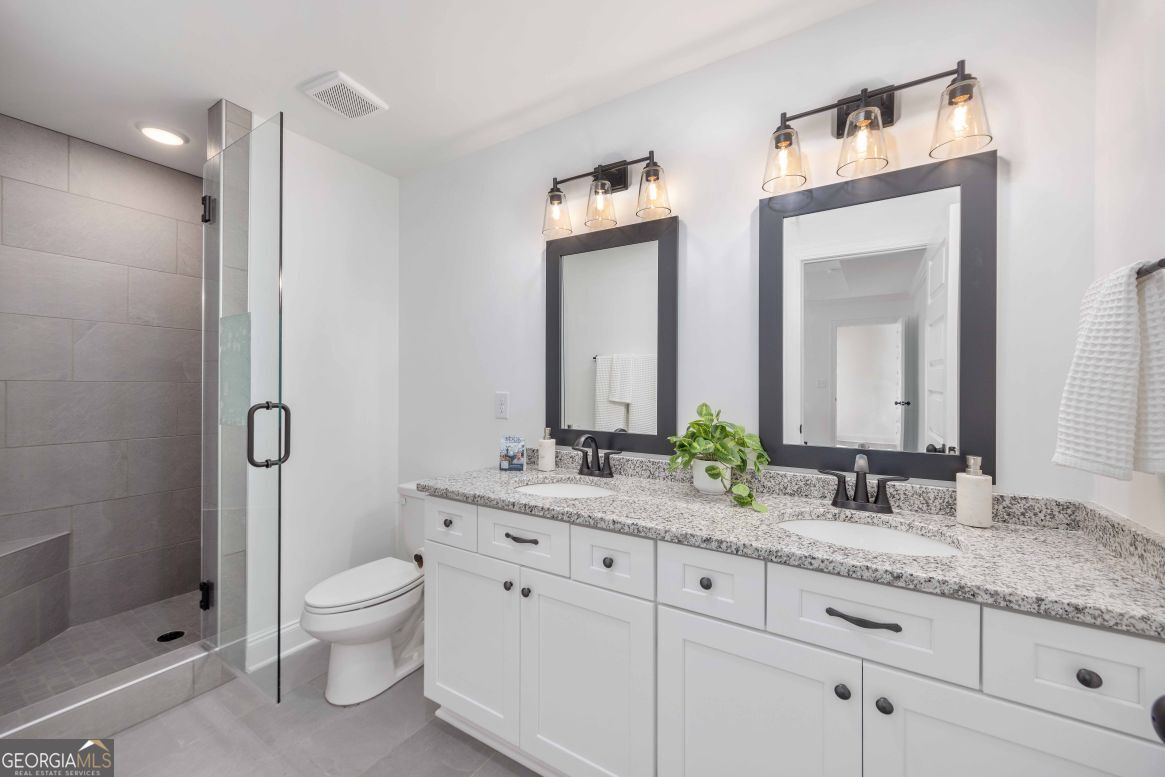 21 Rivers Edge Lane Franklin, GA 30217 - Photo 17 of 26 a bathroom with a granite countertop toilet sink and mirror