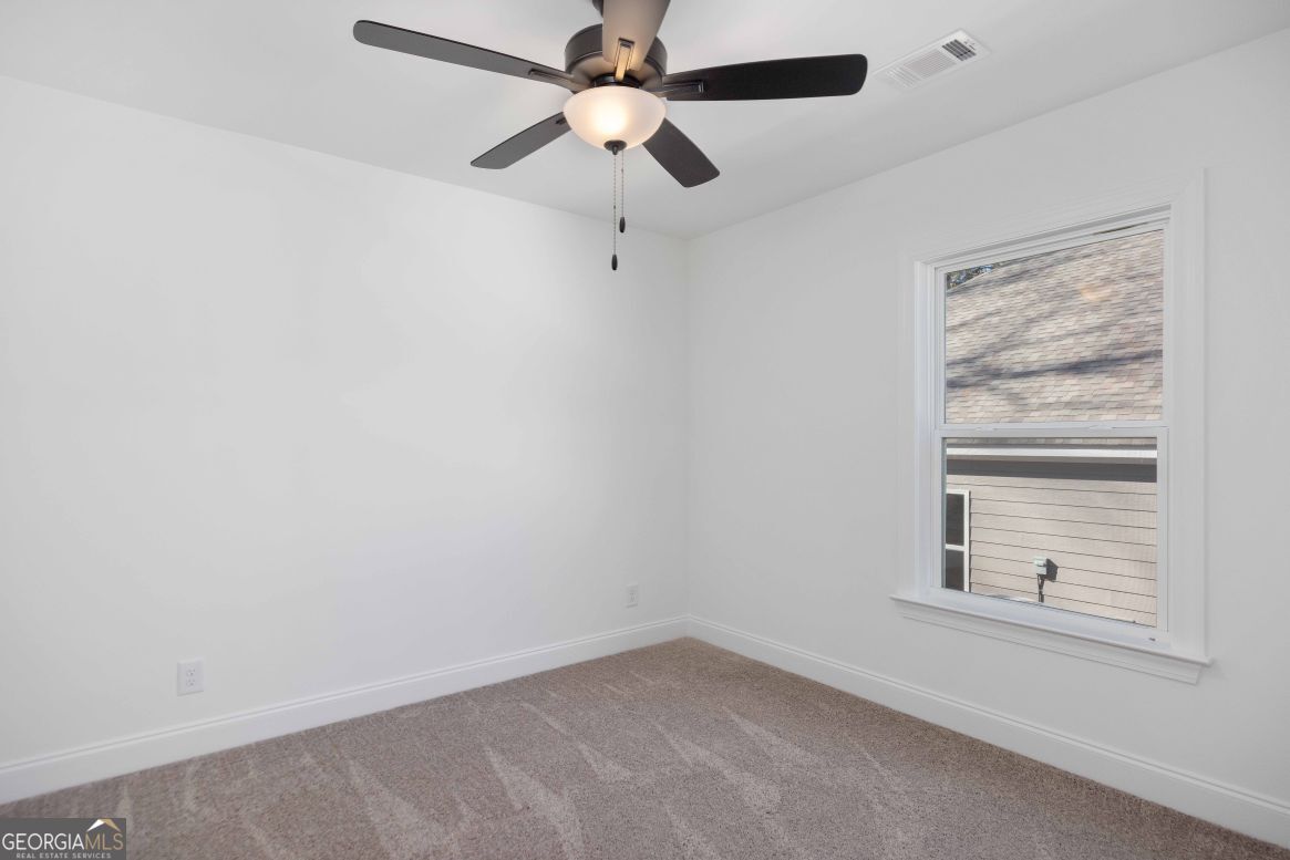 21 Rivers Edge Lane Franklin, GA 30217 - Photo 18 of 26 an empty room with a window and a fan