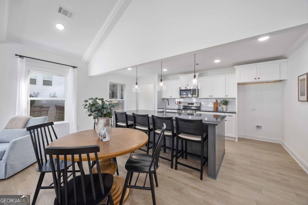 21 Rivers Edge Lane Franklin, GA 30217 - Photo 8 of 26 a kitchen with a dining table chairs and refrigerator