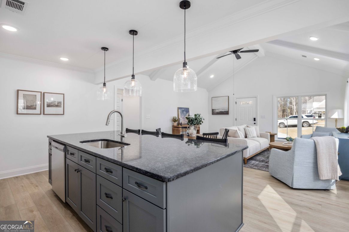 21 Rivers Edge Lane Franklin, GA 30217 - Photo 9 of 26 a kitchen with center island a sink stove and wooden floor
