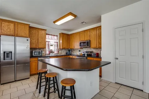a kitchen with stainless steel appliances granite countertop a stove microwave and sink