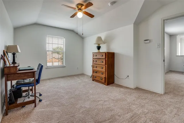 a living room with furniture and a ceiling fan