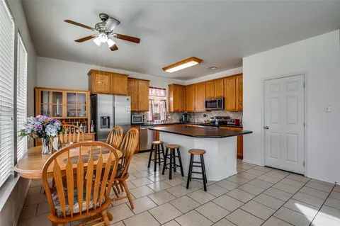 a kitchen with stainless steel appliances granite countertop a sink a window and a refrigerator