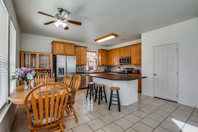 a kitchen with stainless steel appliances granite countertop a sink a window and a refrigerator