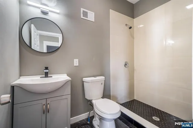a bathroom with a sink mirror and toilet