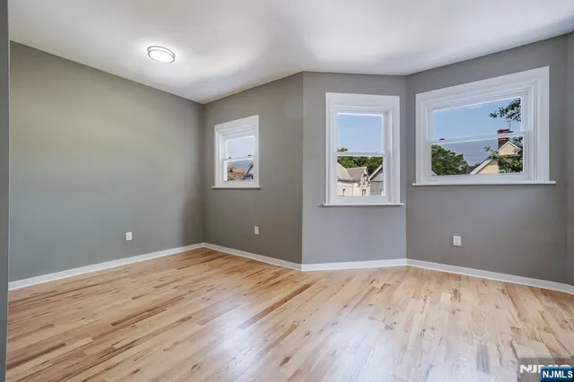 a view of room with window and wooden floor