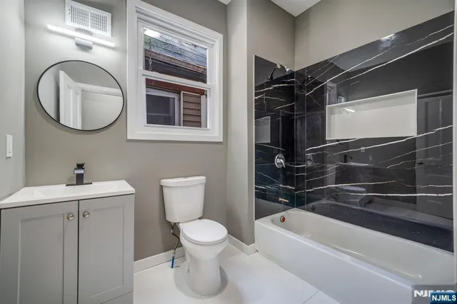a bathroom with a toilet a sink and bathtub