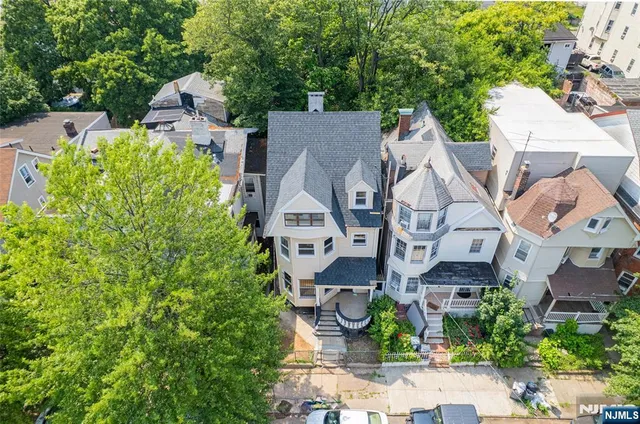 an aerial view of multiple houses with yard