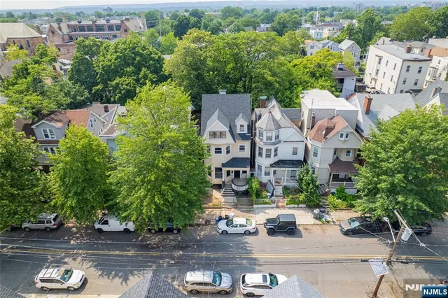 an aerial view of multiple houses with yard