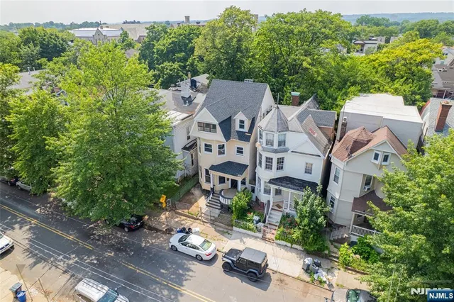 an aerial view of a house with yard swimming pool and outdoor seating