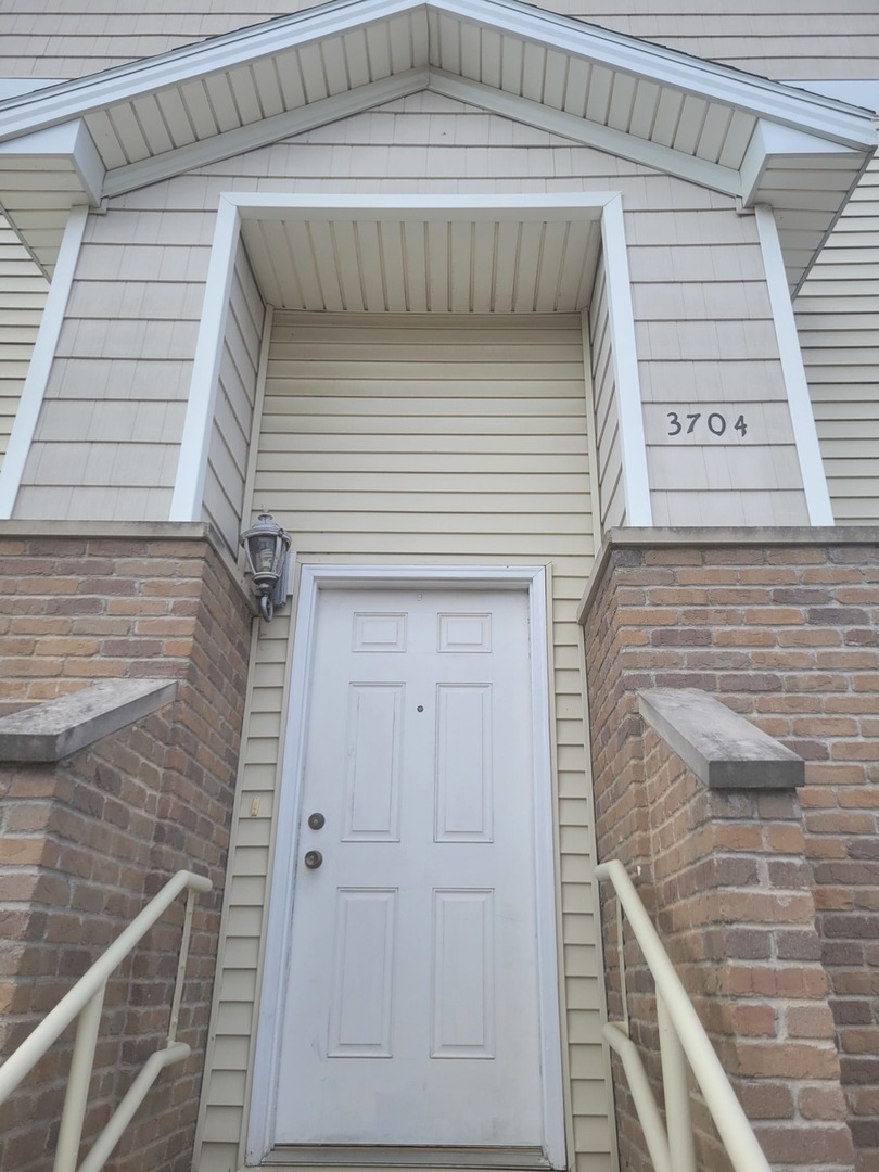 3704 Balcary Bay, Unit 3704 Champaign, IL 61822 - Photo 1 of 15 a front view of a house with white wall