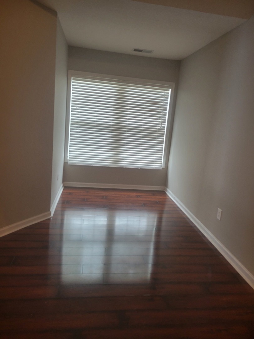 3704 Balcary Bay, Unit 3704 Champaign, IL 61822 - Photo 12 of 15 a view of empty room with wooden floor and fan