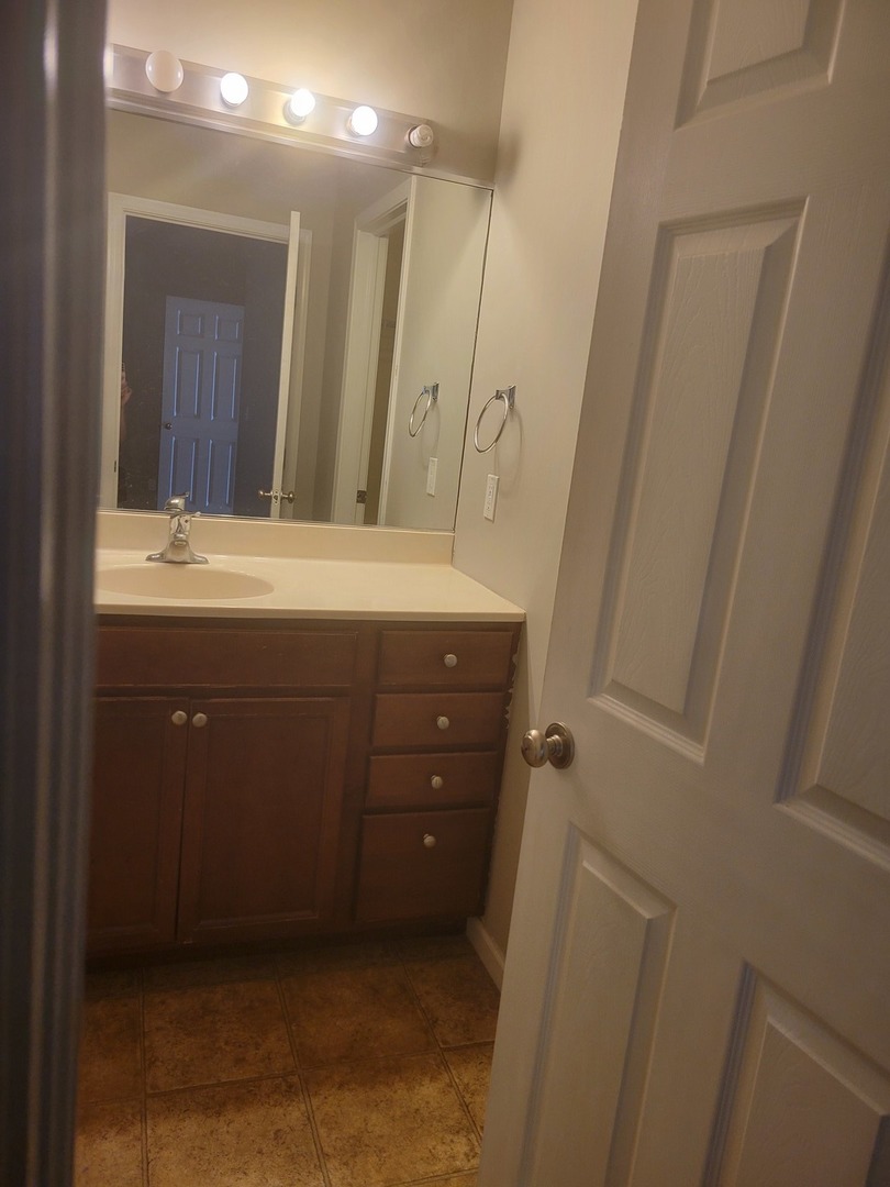 3704 Balcary Bay, Unit 3704 Champaign, IL 61822 - Photo 14 of 15 a bathroom with a sink a toilet and a mirror