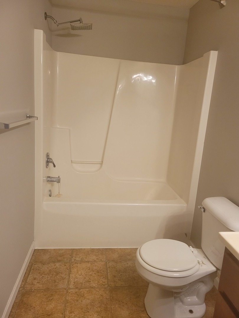 3704 Balcary Bay, Unit 3704 Champaign, IL 61822 - Photo 15 of 15 a white toilet sitting next to a bath tub