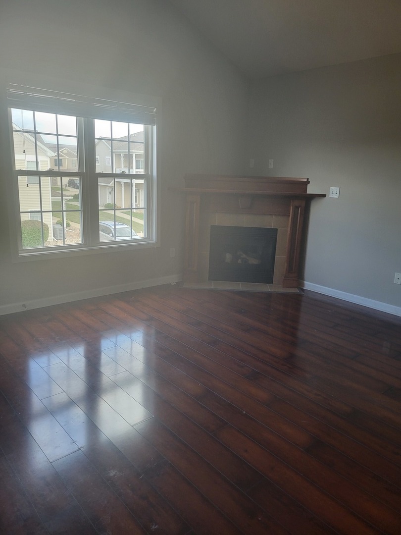 3704 Balcary Bay, Unit 3704 Champaign, IL 61822 - Photo 4 of 15 an empty room with wooden floor and windows