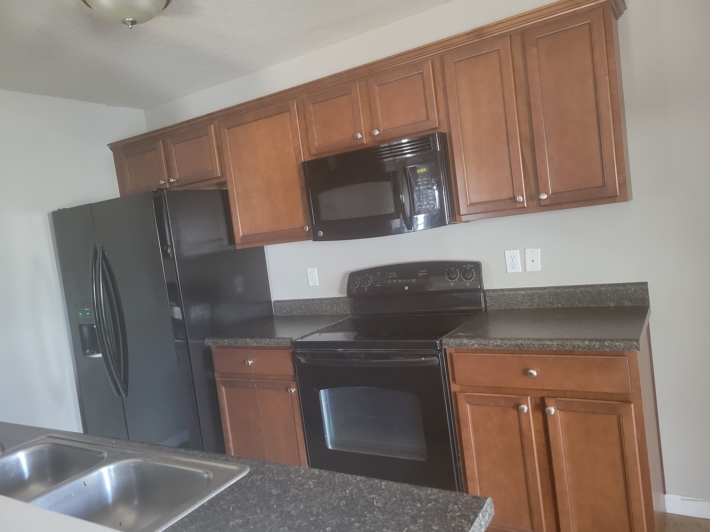 3704 Balcary Bay, Unit 3704 Champaign, IL 61822 - Photo 5 of 15 a kitchen with stainless steel appliances granite countertop a refrigerator a stove a sink and dishwasher