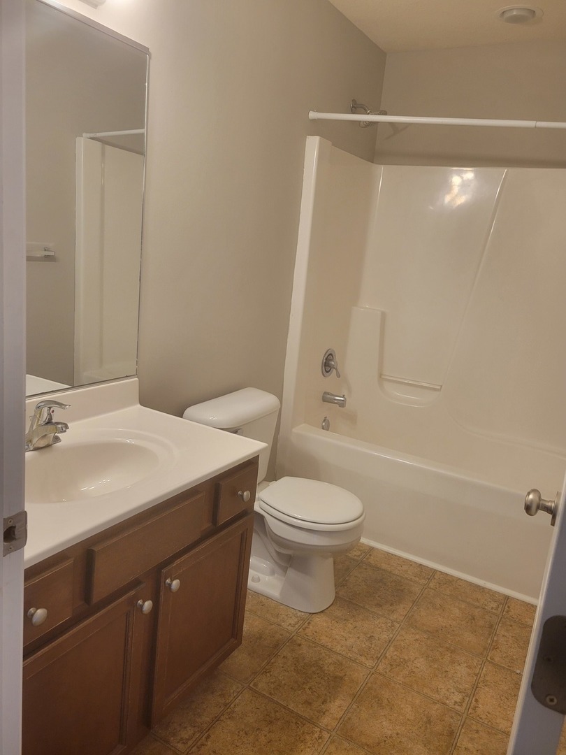 3704 Balcary Bay, Unit 3704 Champaign, IL 61822 - Photo 10 of 15 a bathroom with a sink a toilet and shower