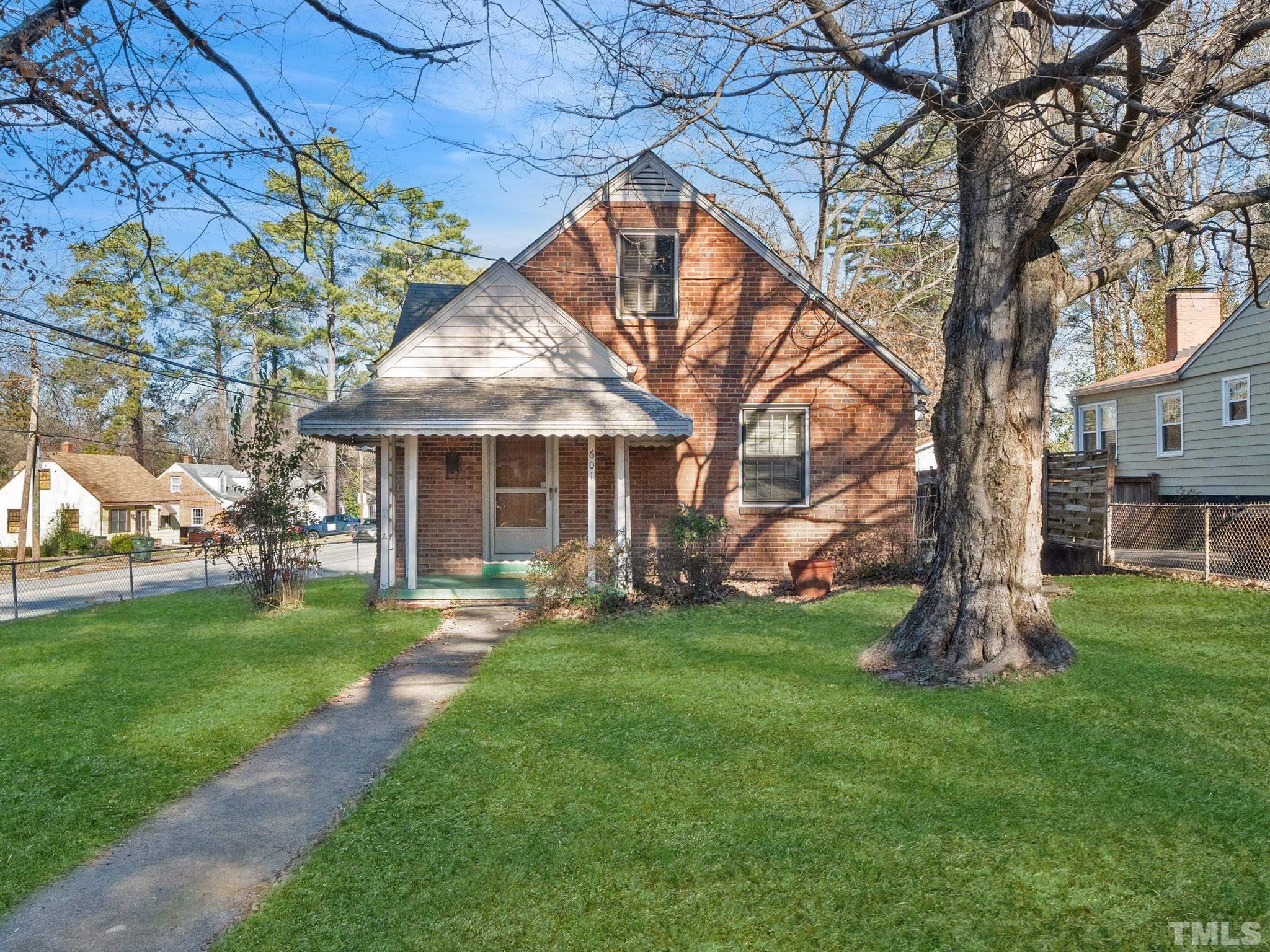 601 Edmund Street Raleigh, NC 27604 - Photo 1 of 4 a front view of a house with a garden