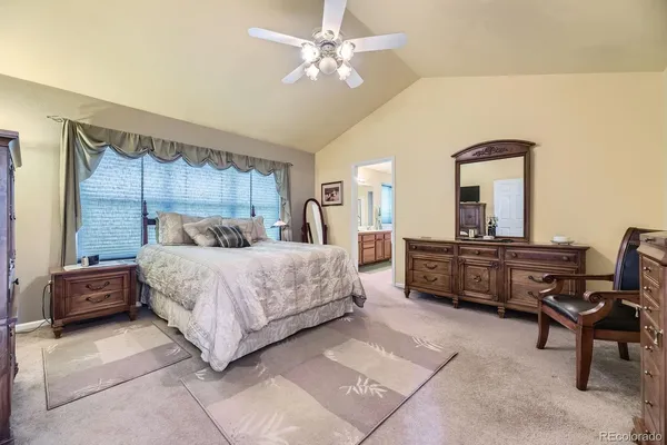 a bedroom with a bed and a lounge chair