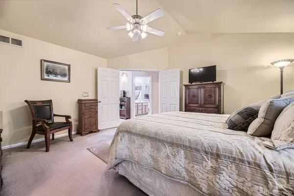 a bedroom with a bed and a television