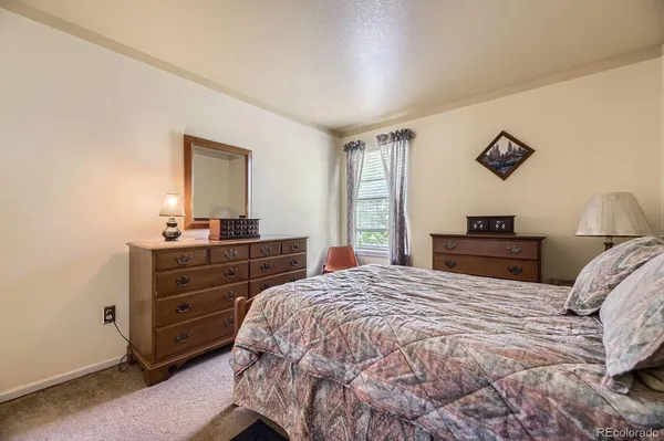 a bedroom with a bed and a dresser