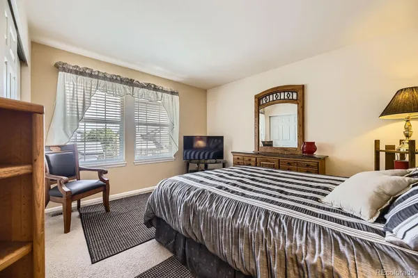 a bedroom with a bed and a windows
