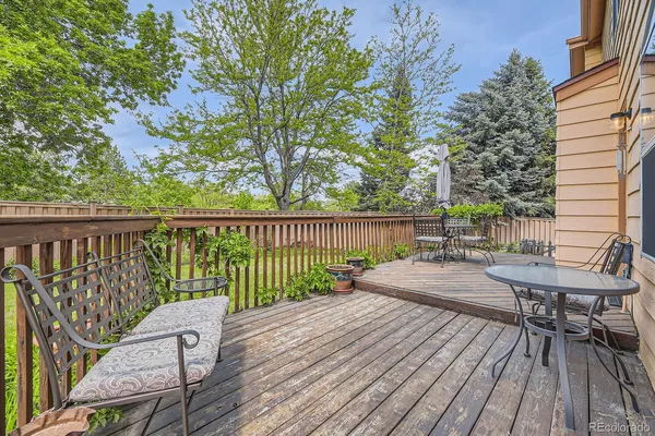 a view of a deck with chairs and wooden floor