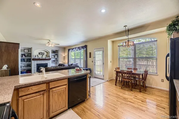 a kitchen with stainless steel appliances granite countertop sink stove and wooden floor