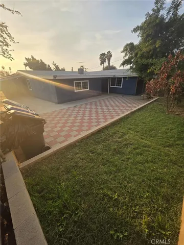 a view of a terrace with lawn chairs