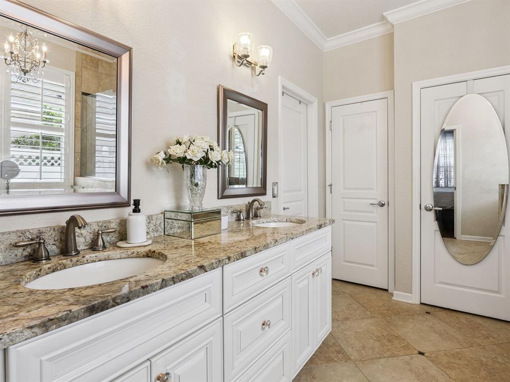 13403 Riggs Way Windermere, FL 34786 - Photo 23 of 47 a bathroom with a granite countertop sink and a mirror