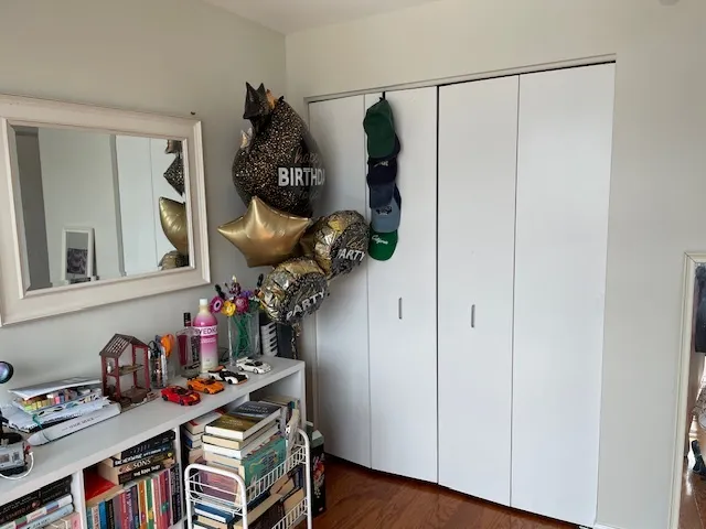 a view of room with guitars and wooden floor