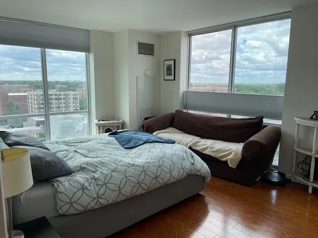 a bedroom with bed couch and window